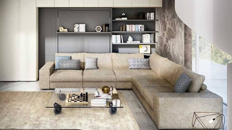 Sofá grande esquinero integrado en mueble con cama de matrimonio y estantes.