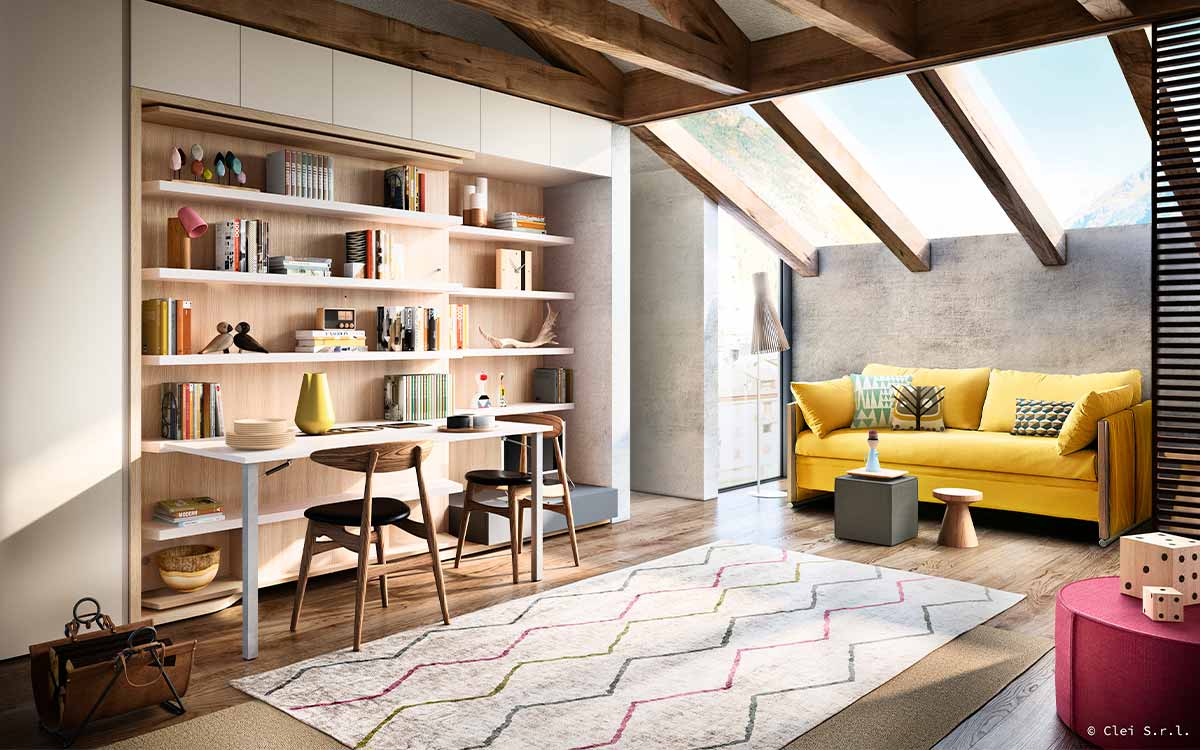 Cama de matrimonio giratoria con gran mesa y librería integradas.