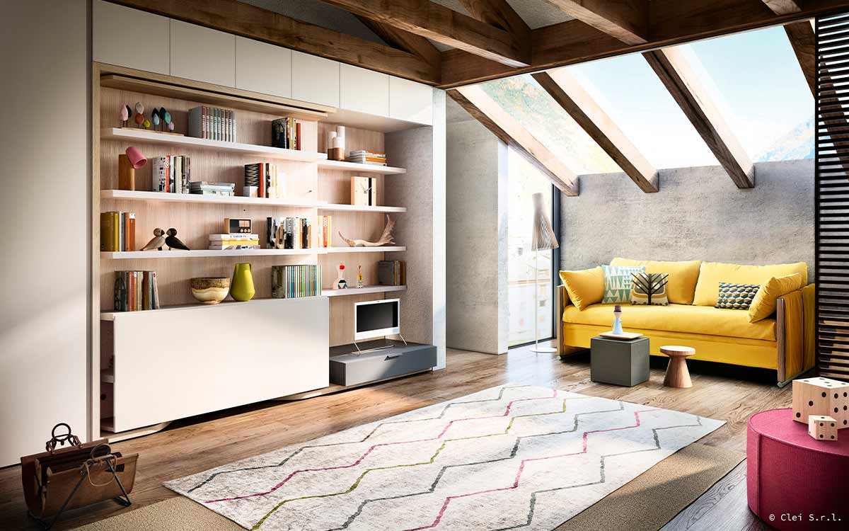 Cama de matrimonio giratoria con gran mesa y librería integradas.