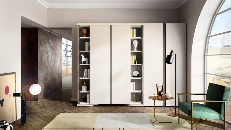 Mueble cama giratoria con librería y armario frontal integrados.