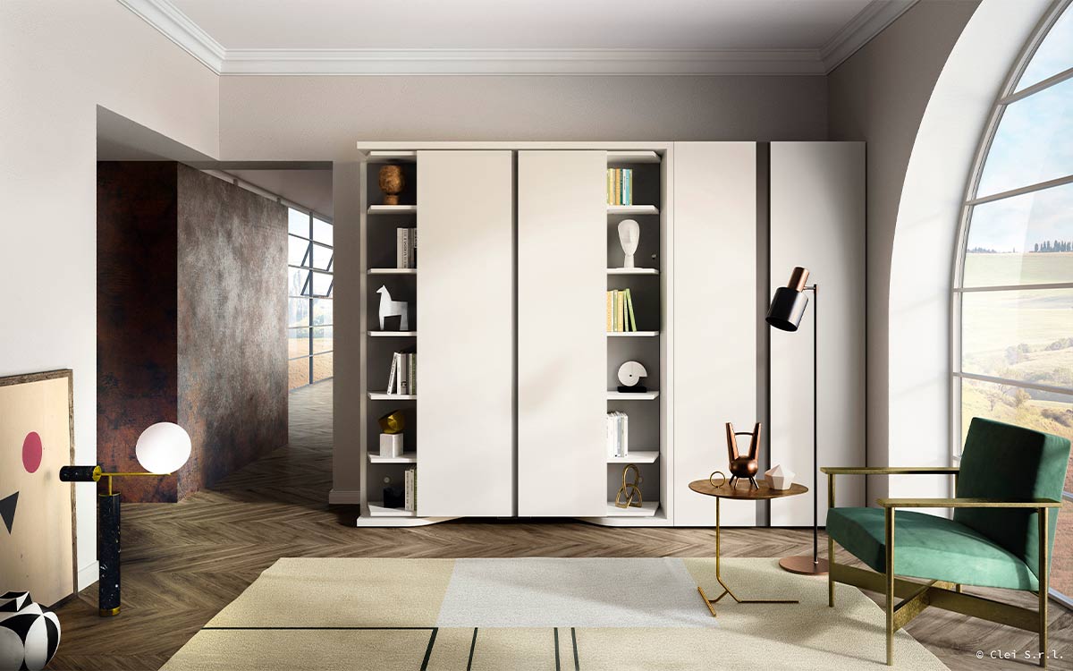 Mueble cama giratoria con librería y armario frontal integrados.