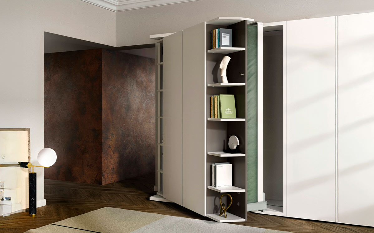 Mueble cama giratoria con librería y armario frontal integrados.