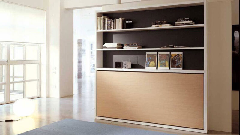 Mueble cama individual abatible con librería superior integrada.