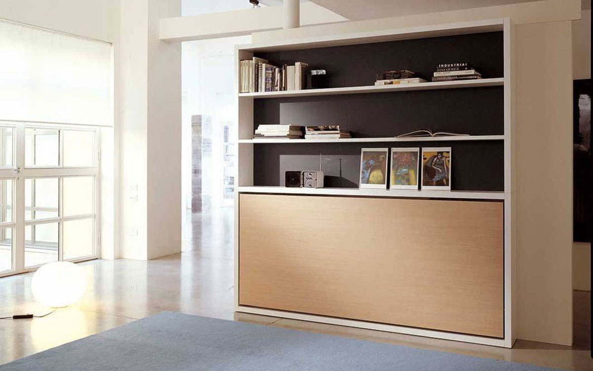 Mueble cama individual abatible con librería superior integrada.