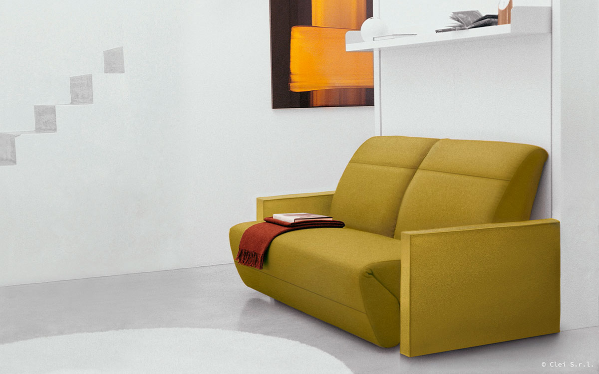 Mueble cama abatible vertical con sofá relax y reposapiés integrado.